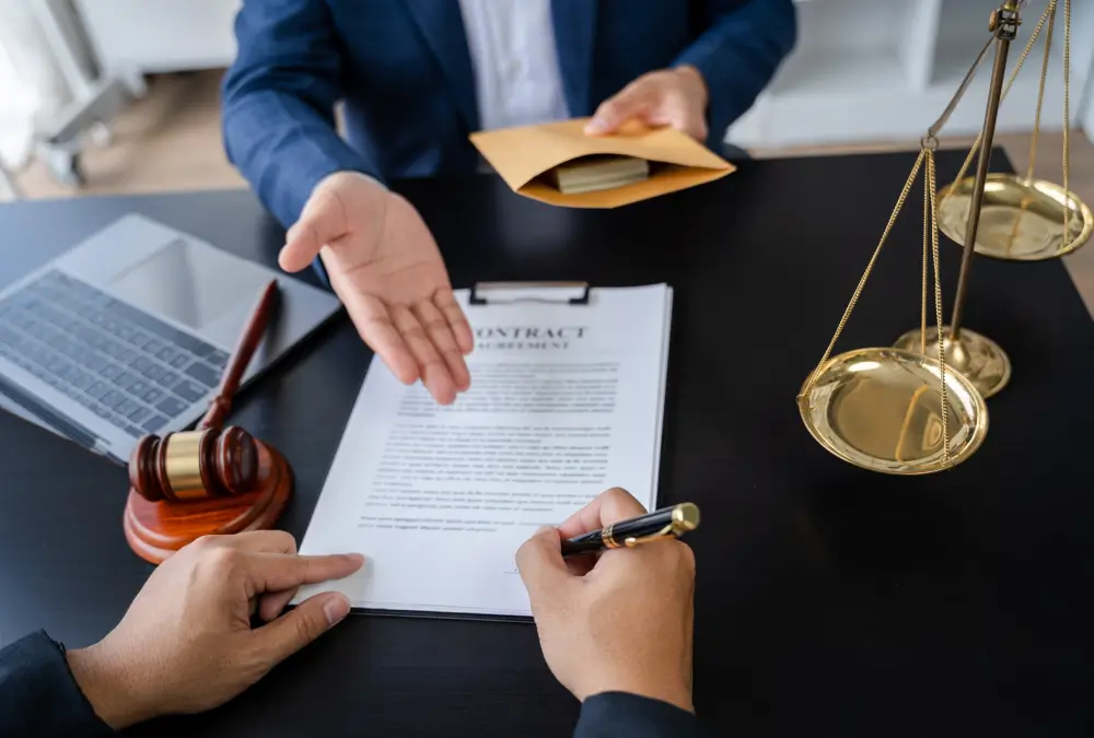 Signing legal contract at office desk.